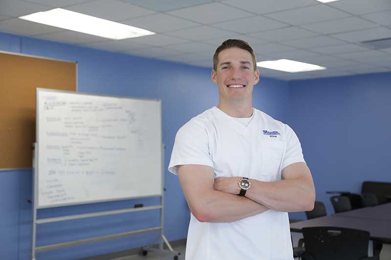 ABSN student standing by whiteboard