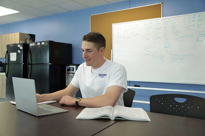 nursing student studying on laptop