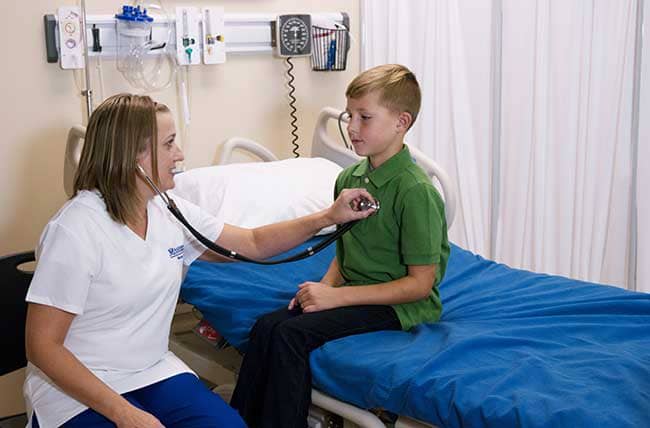 nurse checking child patient's heart beat