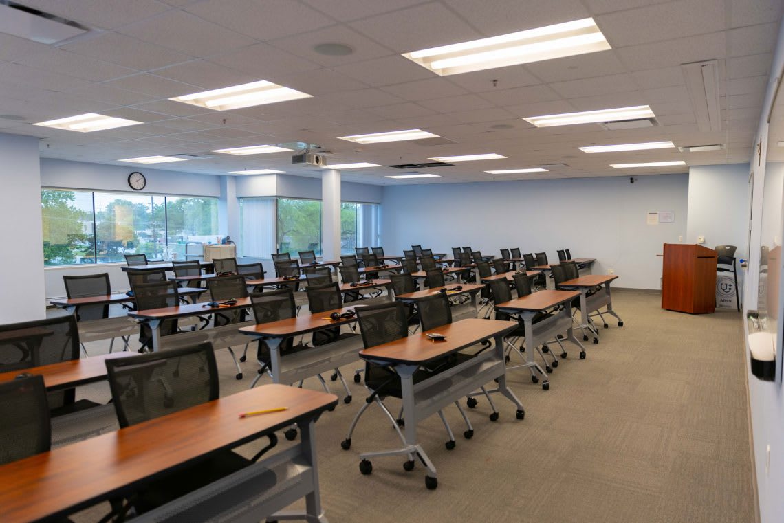 ABSN classroom with tables and chairs