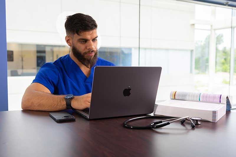 Madonna ABSN student using laptop computer to study