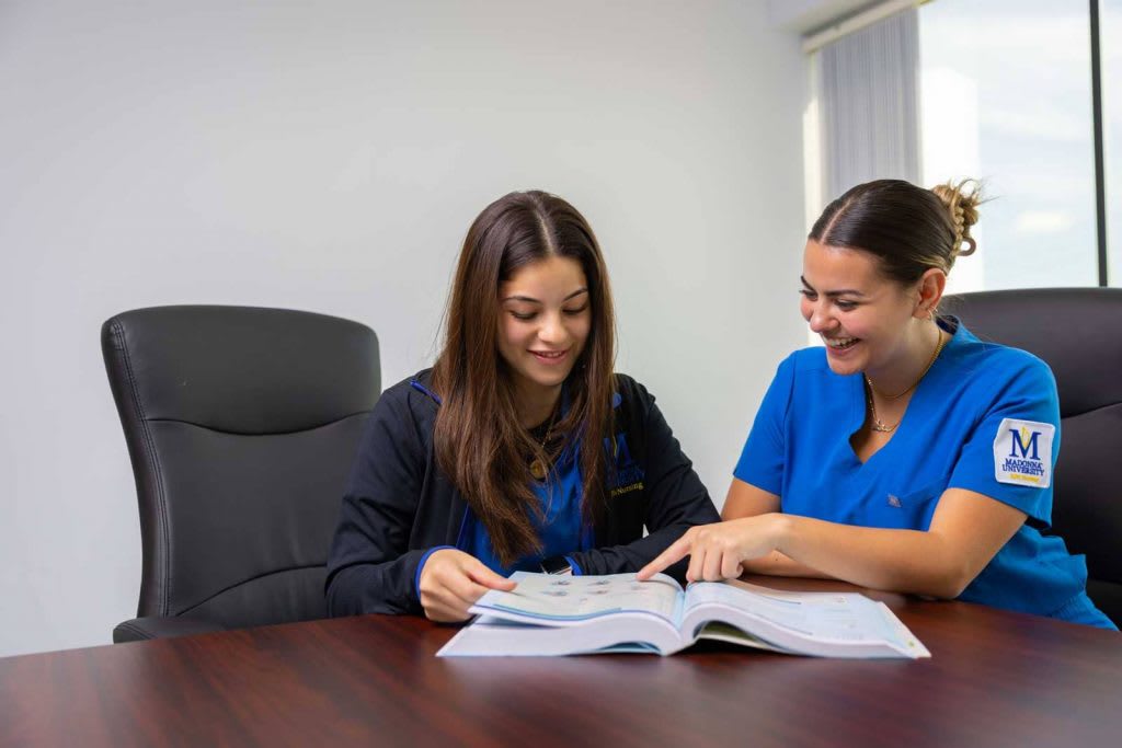 two ABSN students studying together at a desk