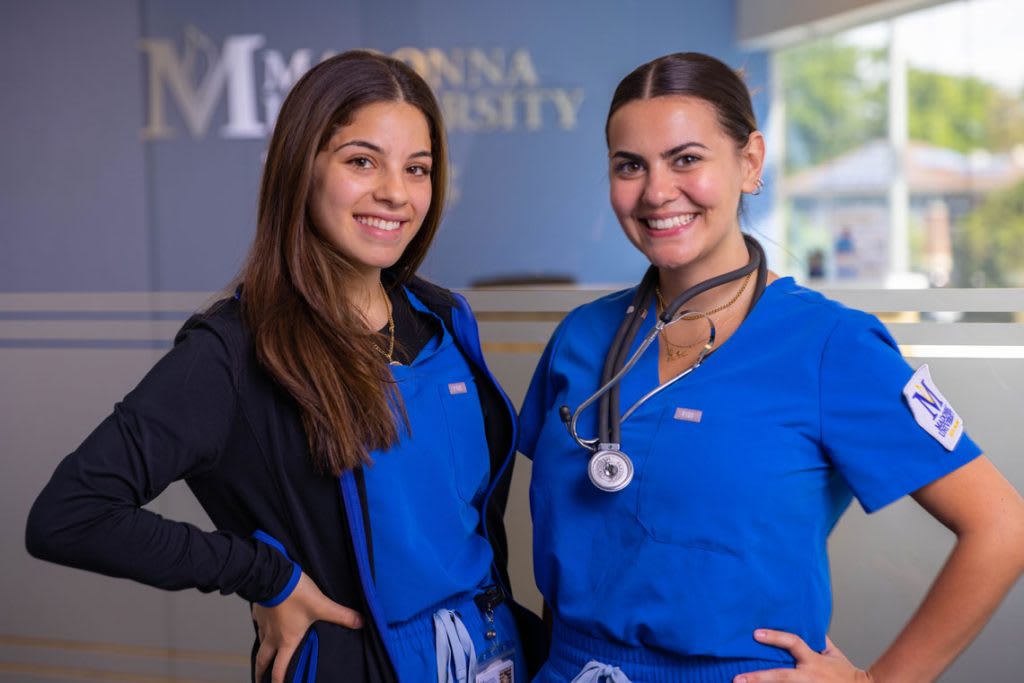 two Madonna nursing students standing and smiling