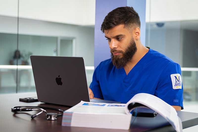 Madonna ABSN student on laptop studying