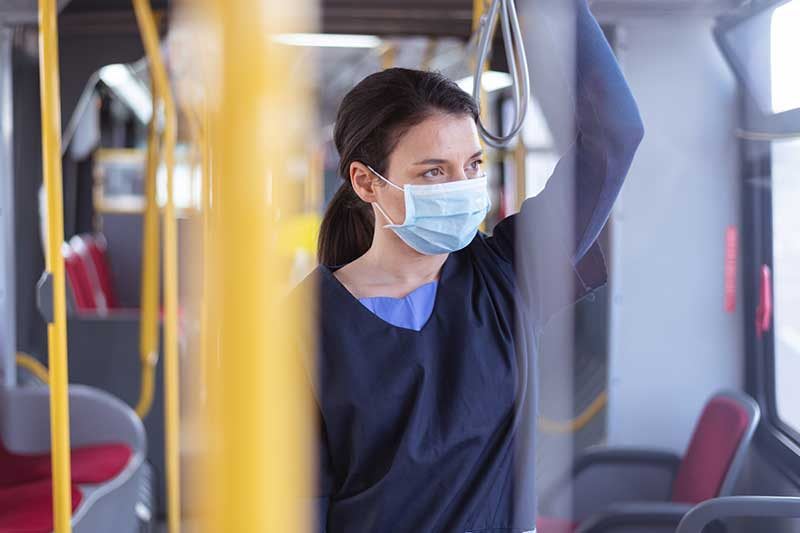 nurse riding on a subway