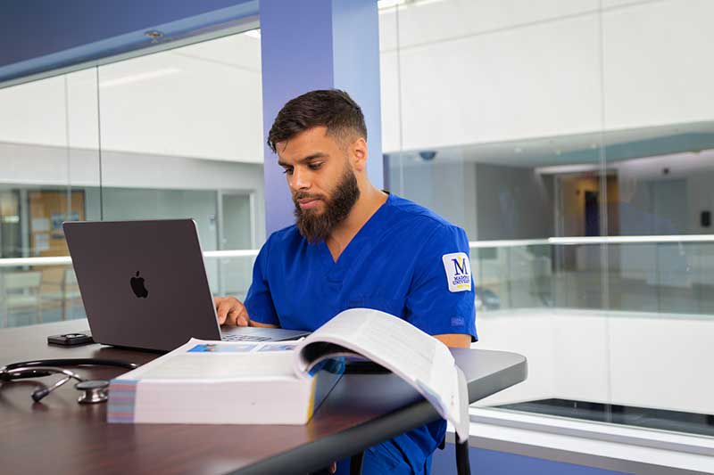 Madonna ABSN student studying at table