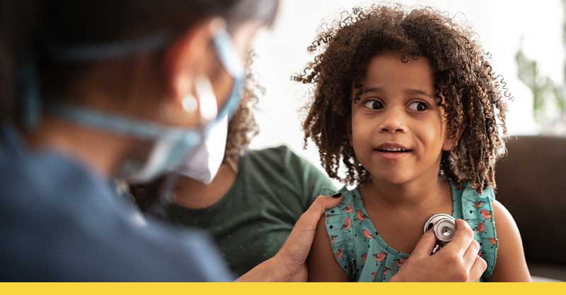 nurse checking child patient's heartbeat