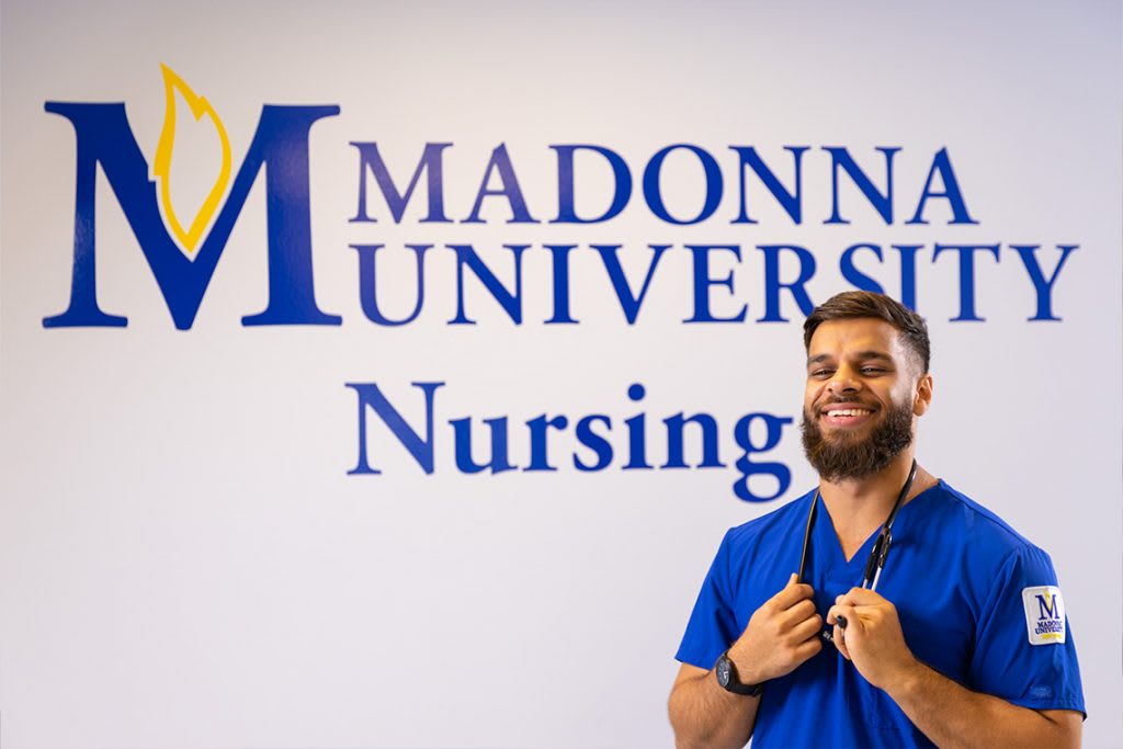 madonna nursing student in front of logo