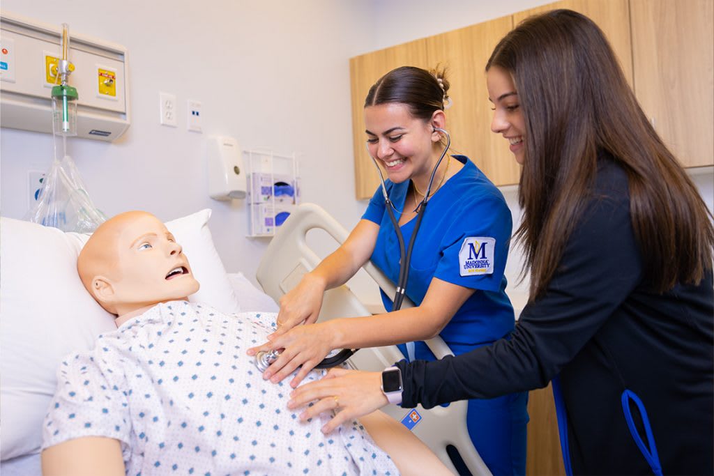 madonna nursing students practicing on manikin