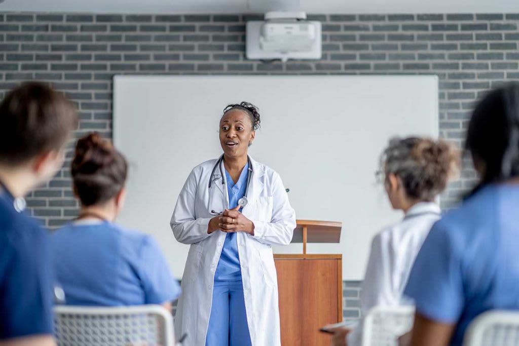 nurse speaking to classroom of other nurses