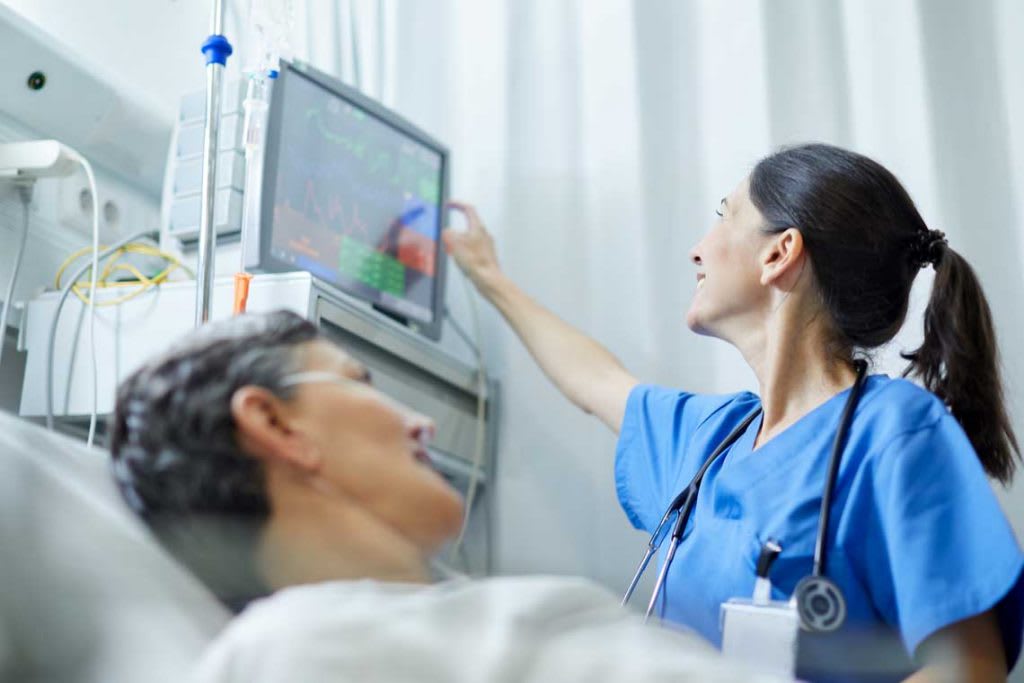 nurse interacting with monitor