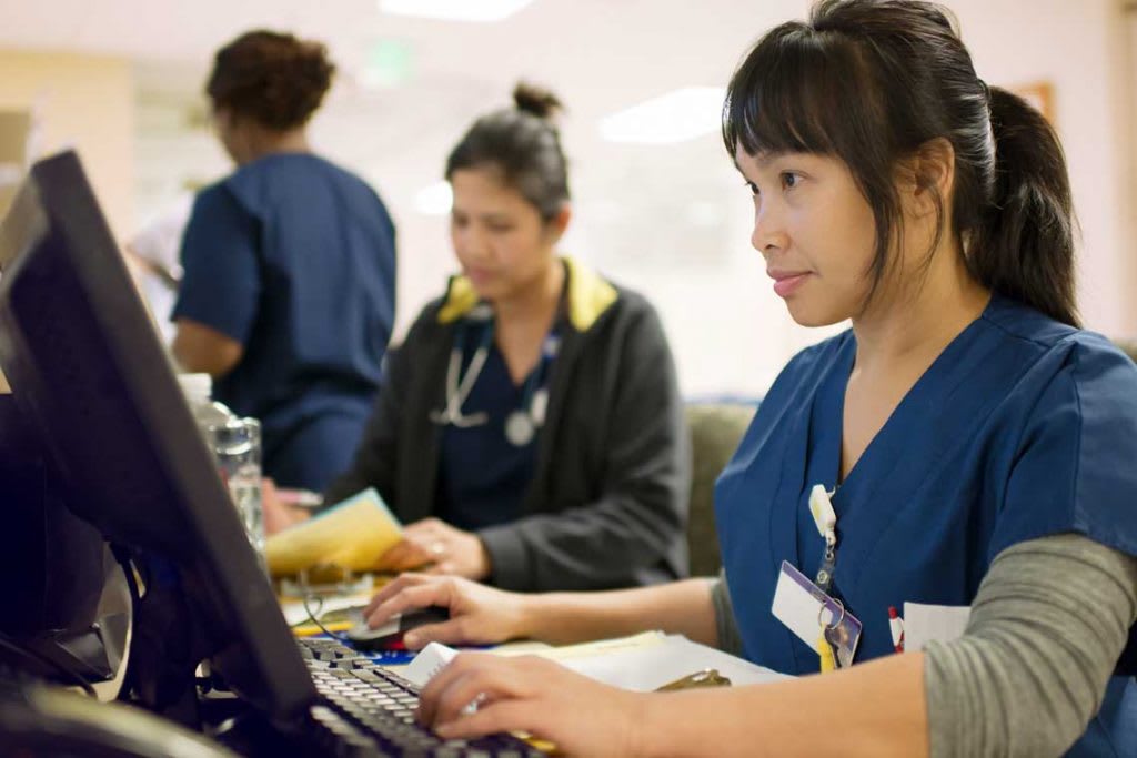 nurses sitting and using computers