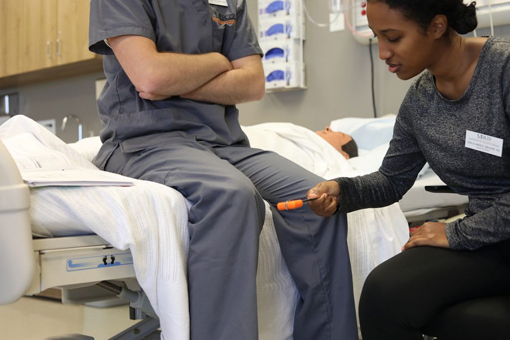 nursing students practicing skills in skills lab