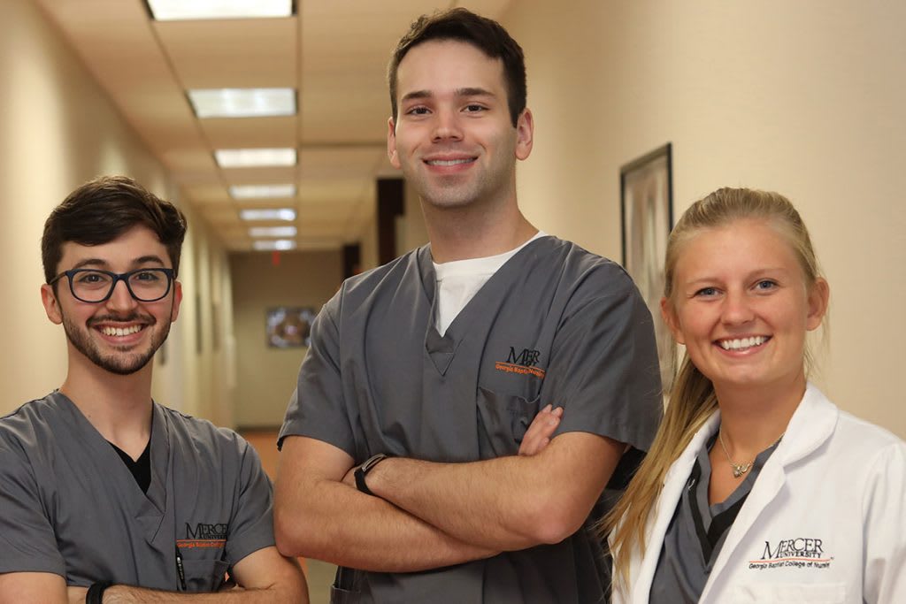 three Mercer nursing students standing in hallway