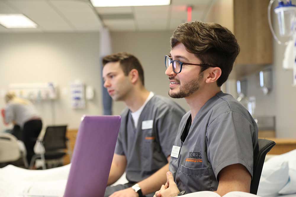 two ABSN students sitting in lab