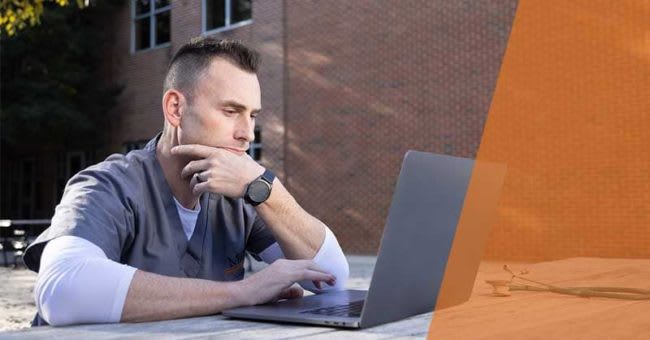 Mercer nursing student sitting outside using laptop