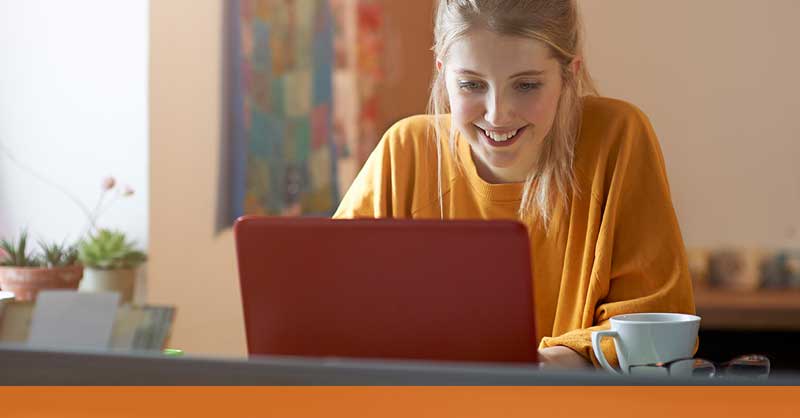 Woman sitting at desk working on laptop