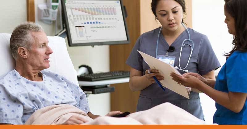 Nursing student at bedside with patient