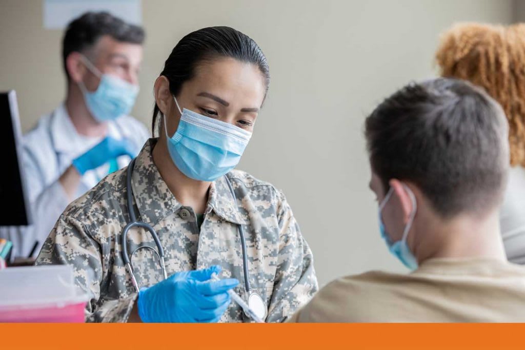 Military nurse giving patient a vaccine shot