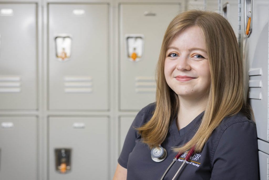 nursing student standing by lockers