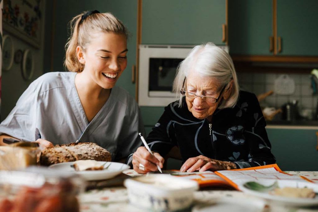 nurse with elderly patient in patient's home