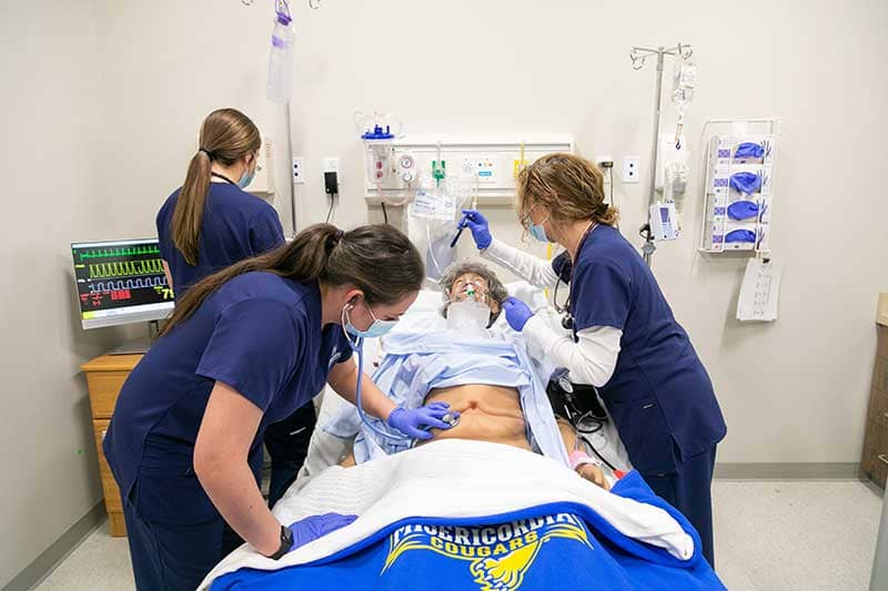 misericordia university nursing students working with simulation manikin