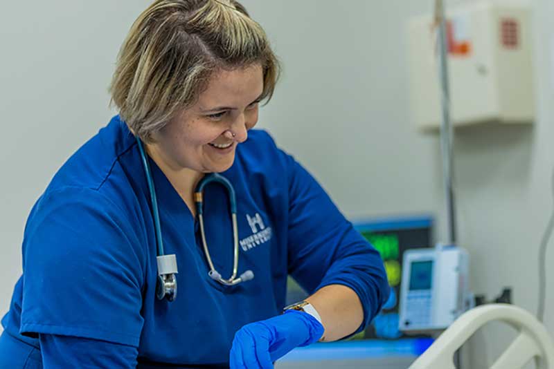 ABSN student using watch to check blood pressure