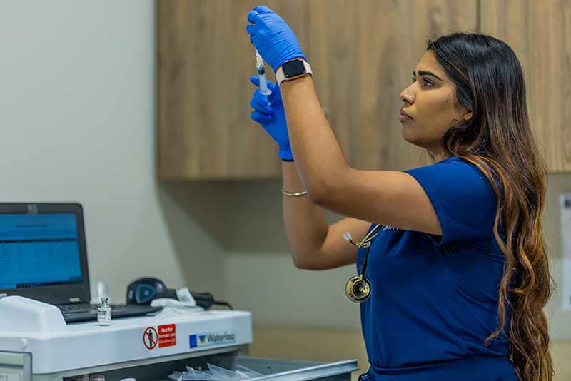 ABSN student using syringe