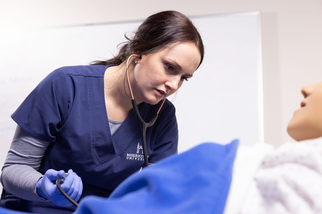 nurse checking manikins heart rate