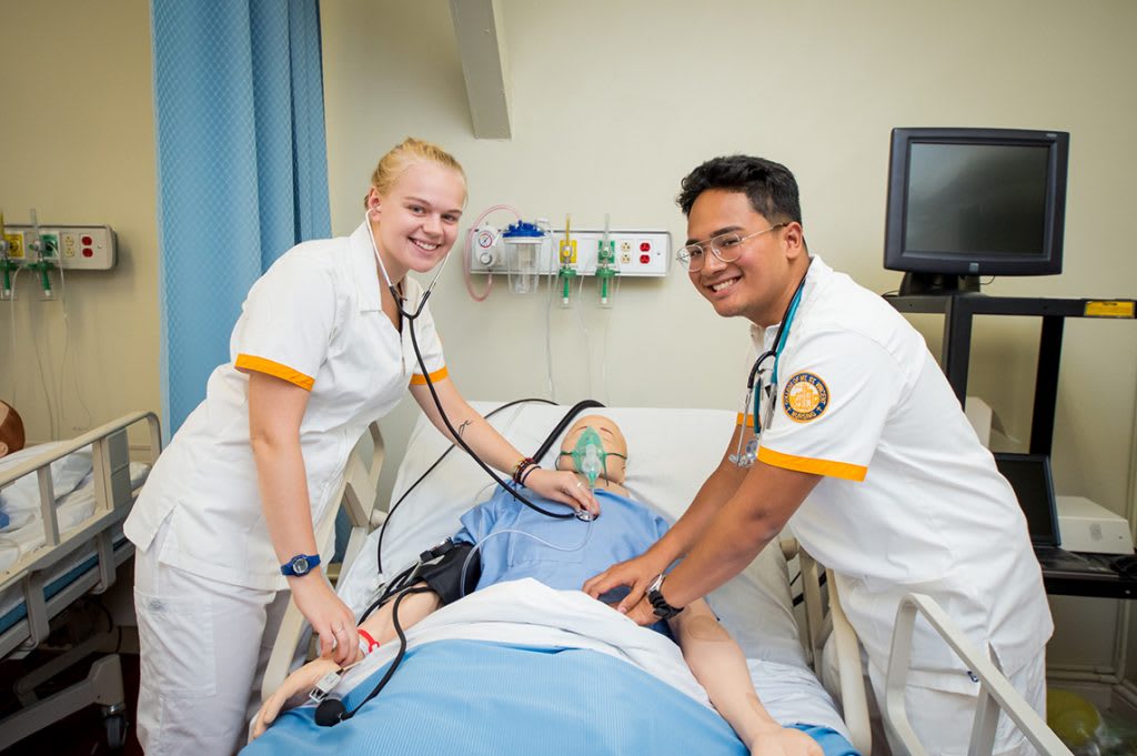 Nursing students practicing on manikin