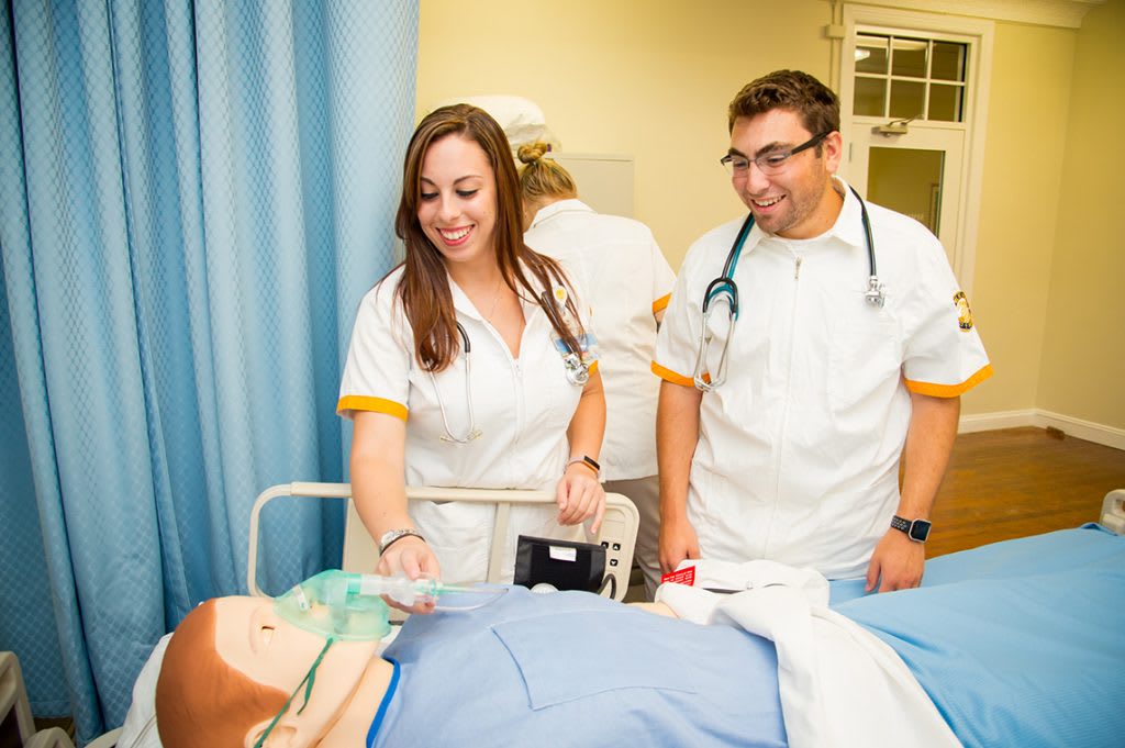 Nursing students practicing on a manikin