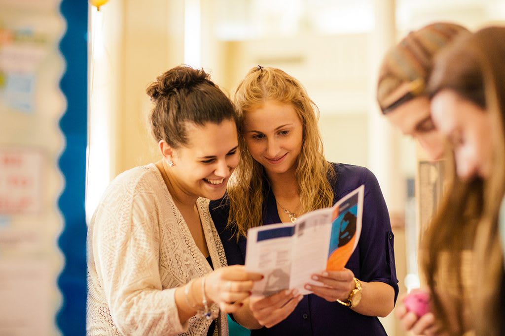 students looking at brochures