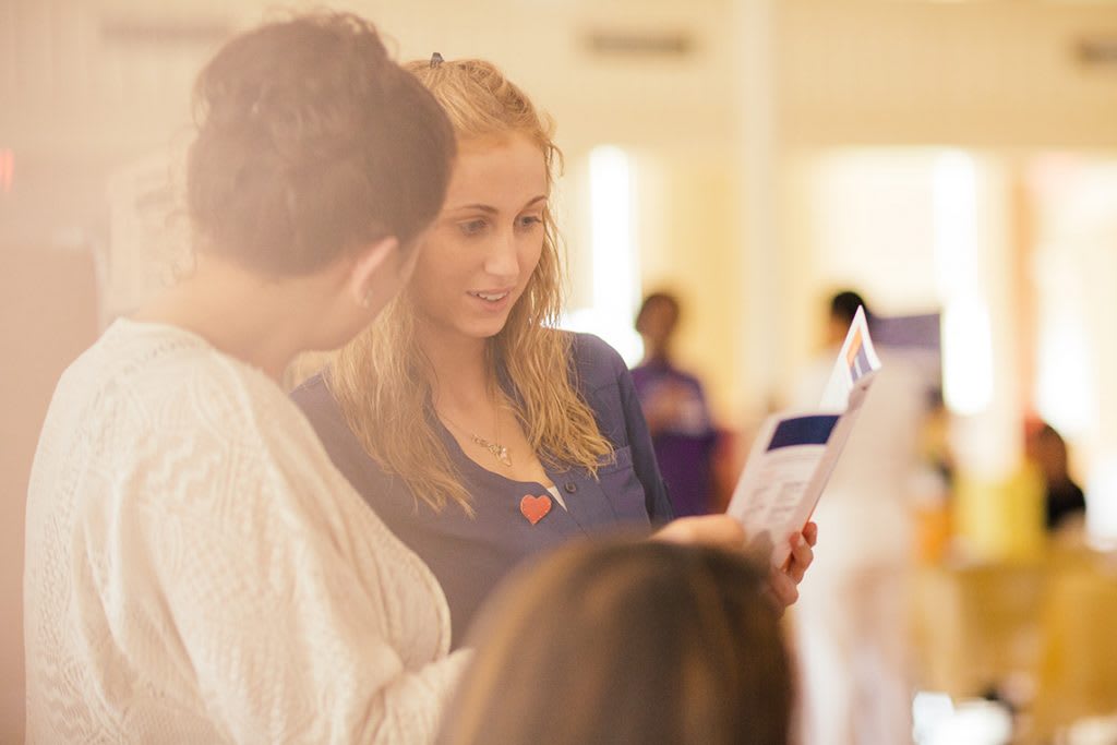 students looking at admissions brochures