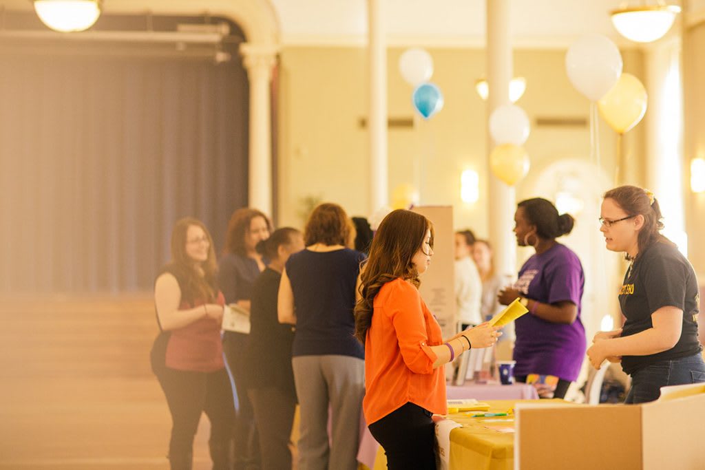 students at campus learning activity with brochures