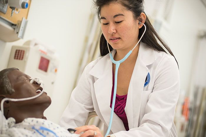 NDMU nursing student using stethoscope