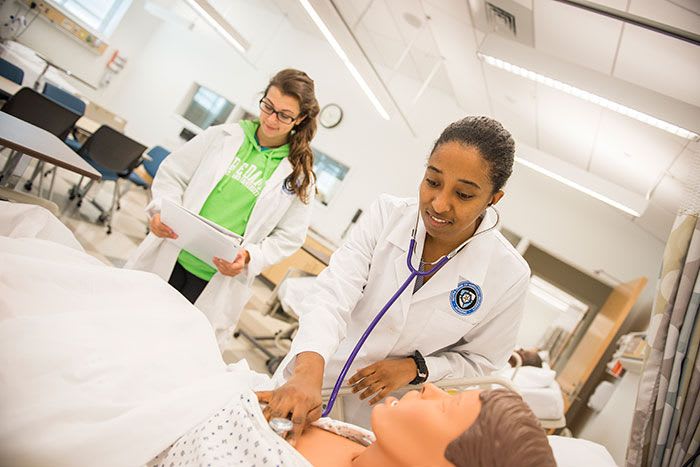 Two NDMU nursing students in simulation lab