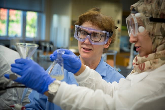 students in goggles working in lab