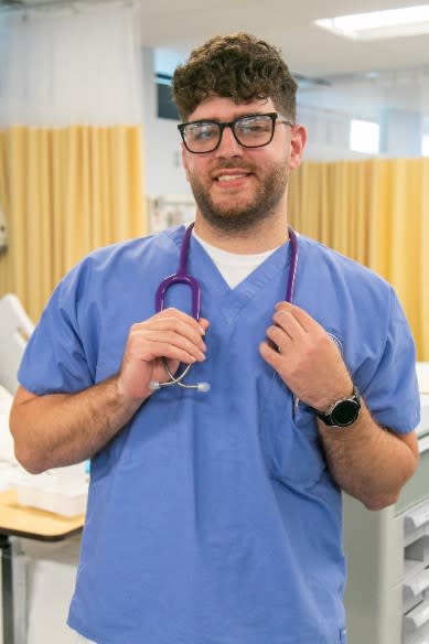NDMU student in scrubs and stethoscope