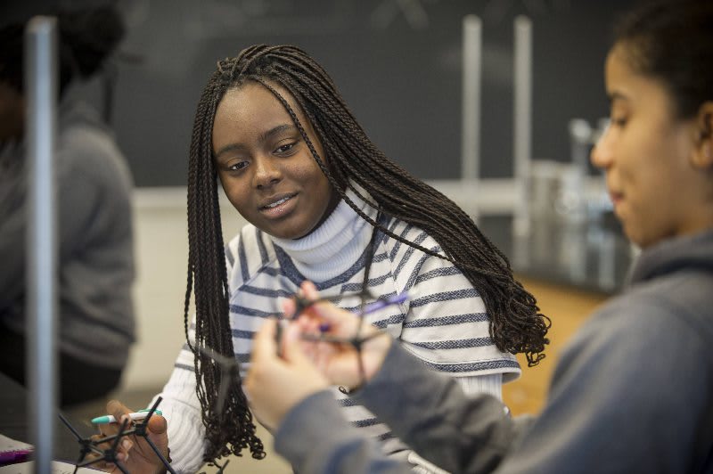Nursing student working with another student in class