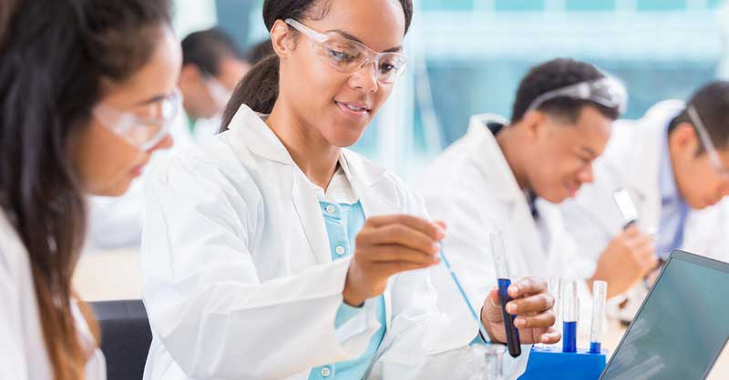 Biology students with testing tubes