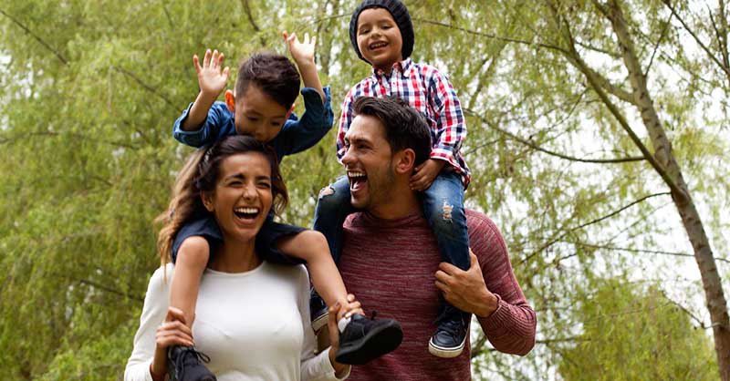 family holding two kids outside