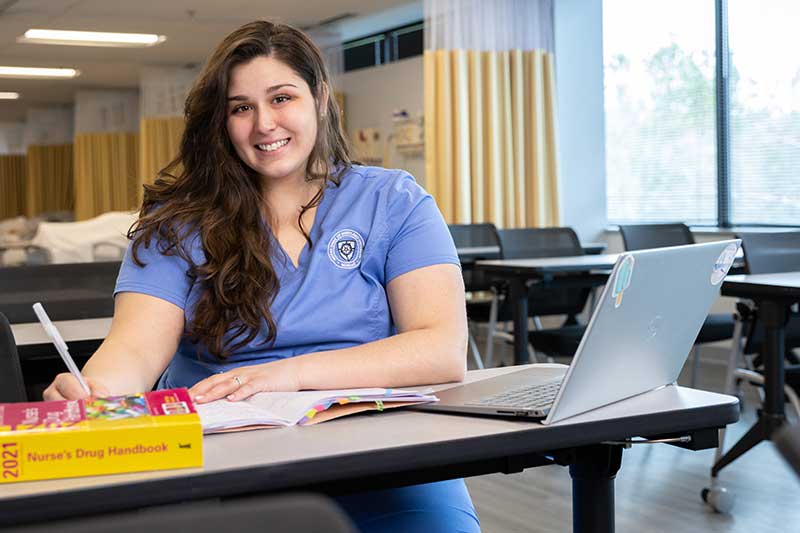 ABSN student studying at desk