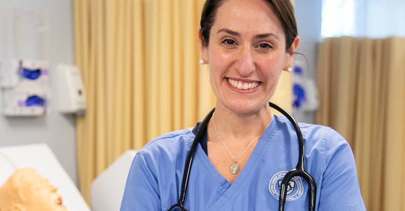 NDMU nursing student wearing blue scrubs