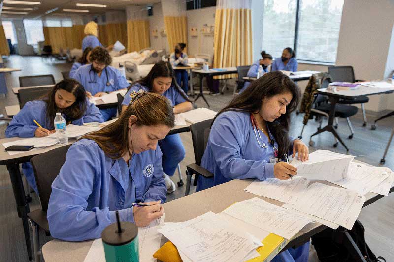 NDMU students working on classwork at desks