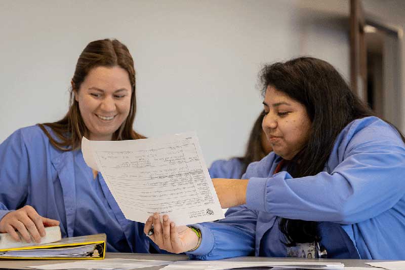 2 nursing students reviewing coursework