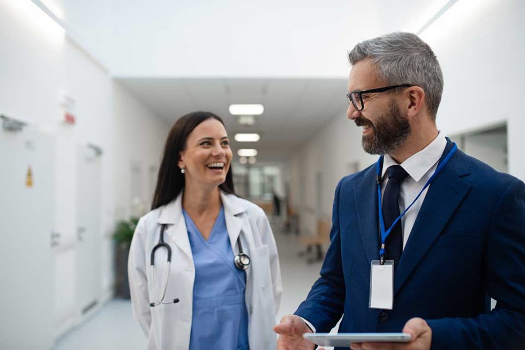 nurse speaking with someone in hallway