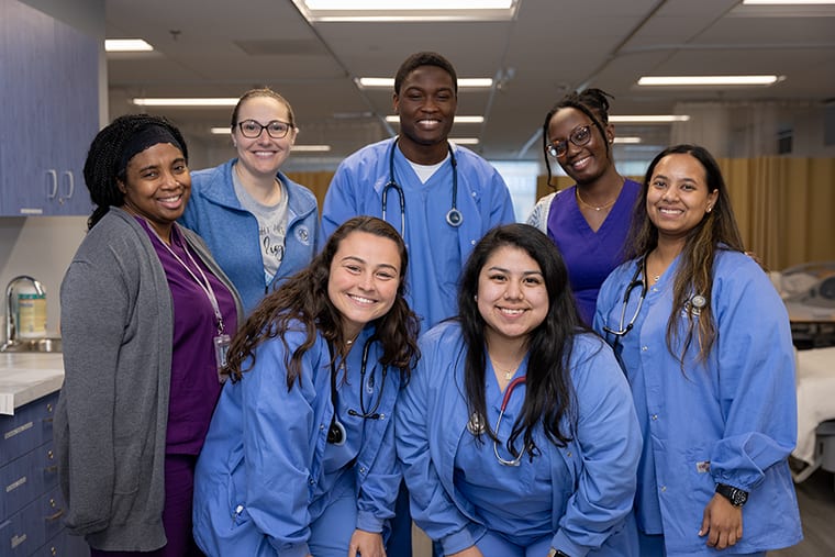 NDMU nursing students in lab smiling at camera