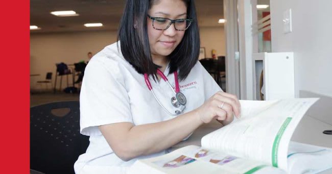 Northeastern ABSN student reading textbook