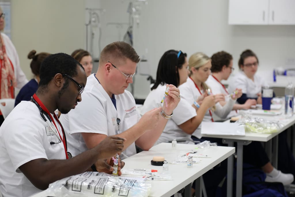 Northeastern nursing students practicing in skills lab