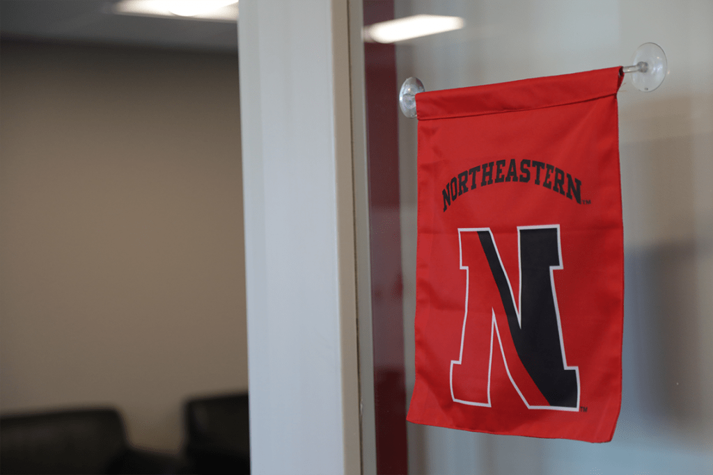 Northeastern flag on door window